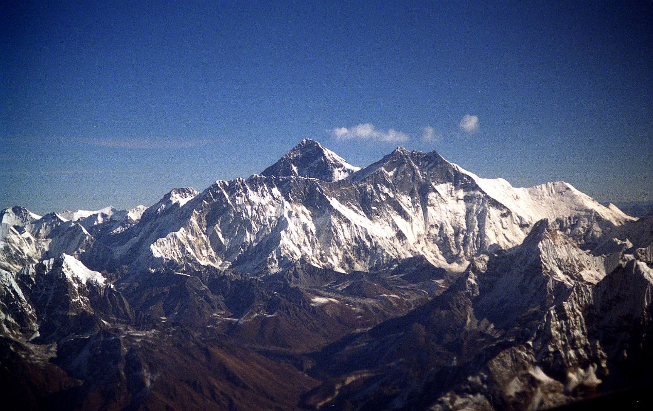 Kathmandu Mountain Flight 08-1 Everest, Nuptse, Lhotse, Ama Dablam 1997 The highlight of the Kathmandu Mountain Flight is when Everest comes into view, poking its head above the Nuptse Lhotse south face. The peak in the middle right is Ama Dablam, one of the most beautiful peaks in the world.